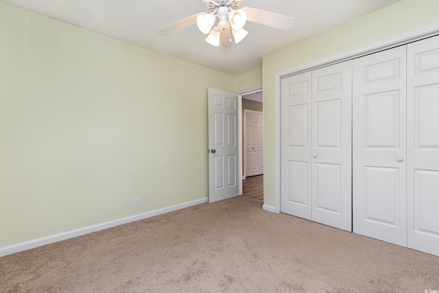 unfurnished bedroom with a closet, light carpet, and ceiling fan