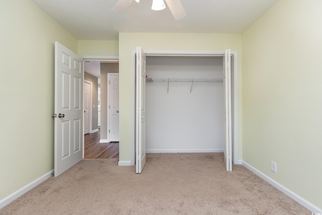 unfurnished bedroom with ceiling fan, a closet, and light colored carpet