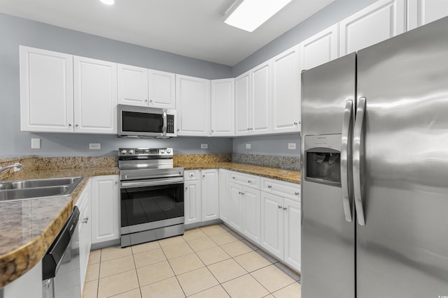 kitchen featuring white cabinets, light tile patterned floors, sink, and appliances with stainless steel finishes