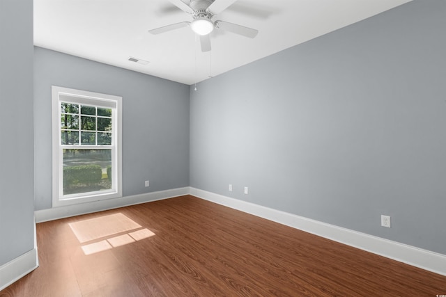 unfurnished room with hardwood / wood-style flooring and ceiling fan