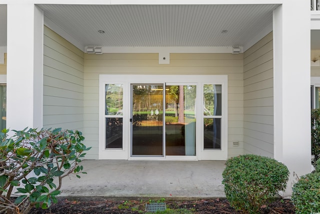 view of exterior entry featuring a patio