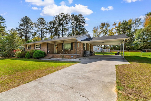 single story home featuring a porch, a carport, and a front yard