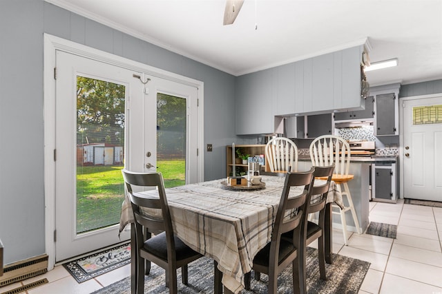 dining area featuring light tile patterned flooring, ceiling fan, and crown molding