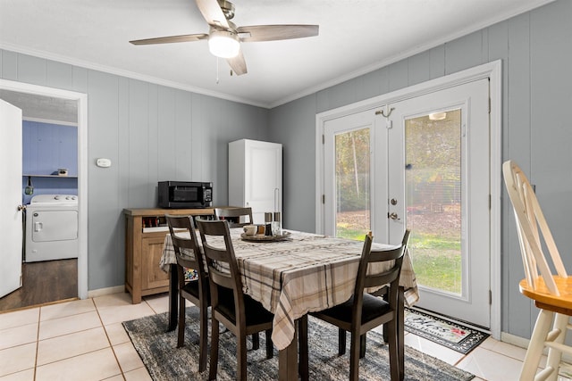 tiled dining room with ornamental molding, plenty of natural light, ceiling fan, and washer / dryer