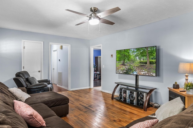 living room featuring a textured ceiling, hardwood / wood-style flooring, and ceiling fan