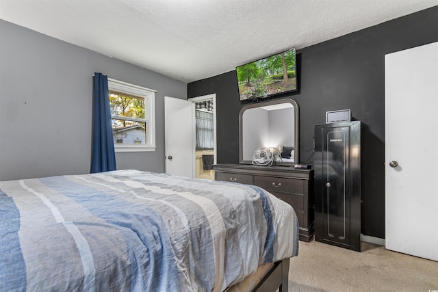 bedroom featuring a textured ceiling and light carpet