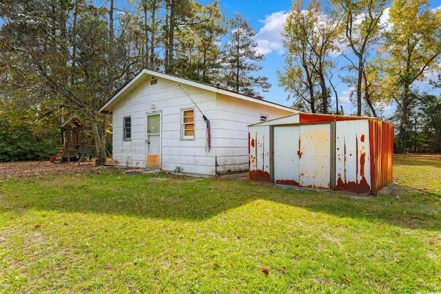 exterior space with a shed, a playground, and a yard