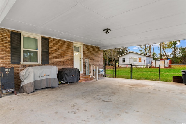 view of patio / terrace featuring grilling area and a shed