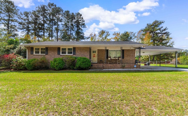 ranch-style home featuring a porch, a carport, and a front lawn