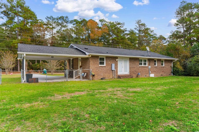 back of house featuring a yard and a carport