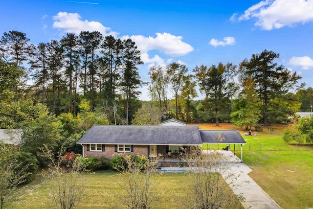 view of front of home with a front yard and a carport