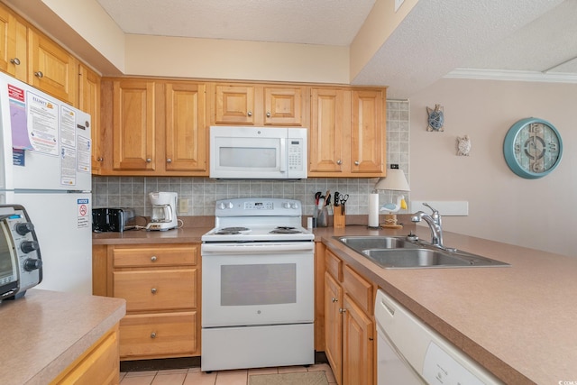 kitchen featuring light tile patterned floors, white appliances, sink, and backsplash