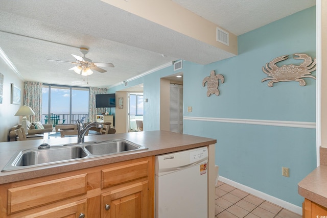 kitchen featuring dishwasher, a textured ceiling, sink, and crown molding