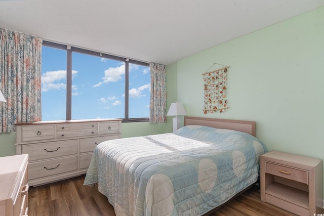 bedroom with dark hardwood / wood-style flooring