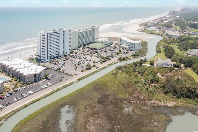 drone / aerial view featuring a beach view and a water view