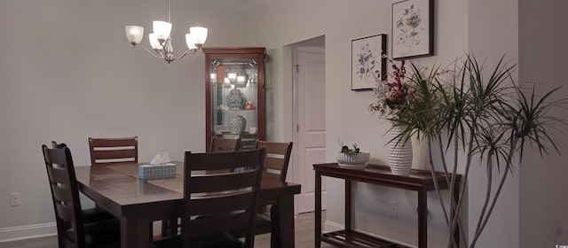 dining space with a chandelier and hardwood / wood-style flooring