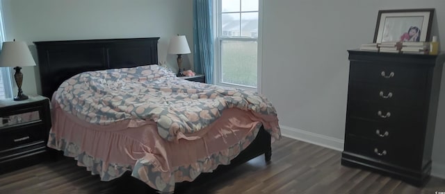 bedroom featuring dark hardwood / wood-style flooring and multiple windows