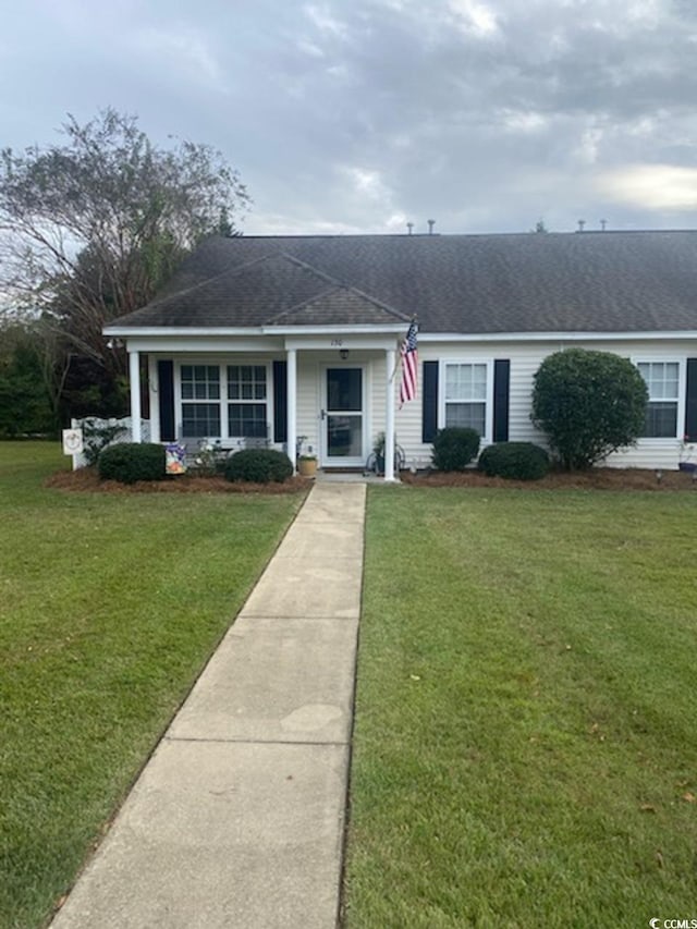 ranch-style home with a front lawn