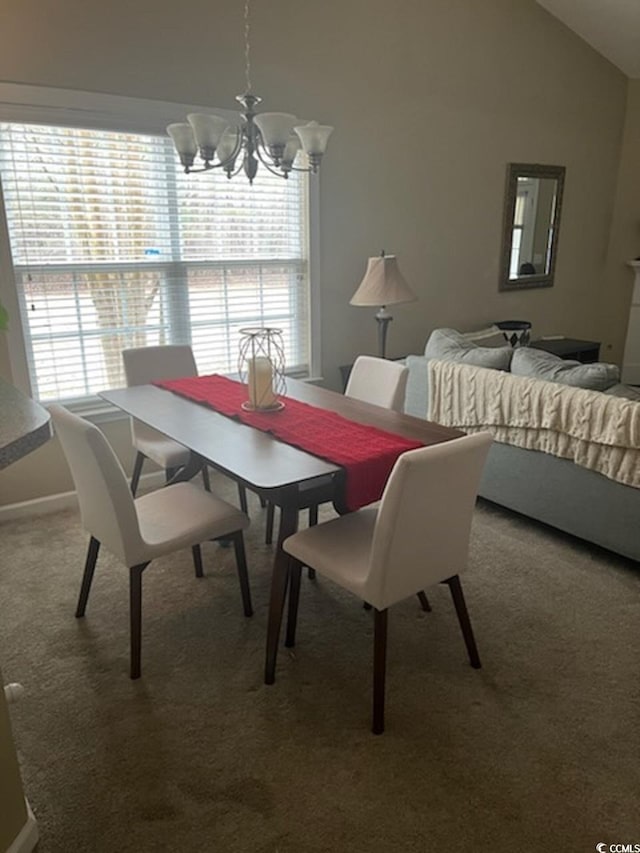 dining area with carpet, lofted ceiling, and a chandelier