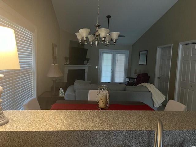 dining area featuring lofted ceiling and a chandelier