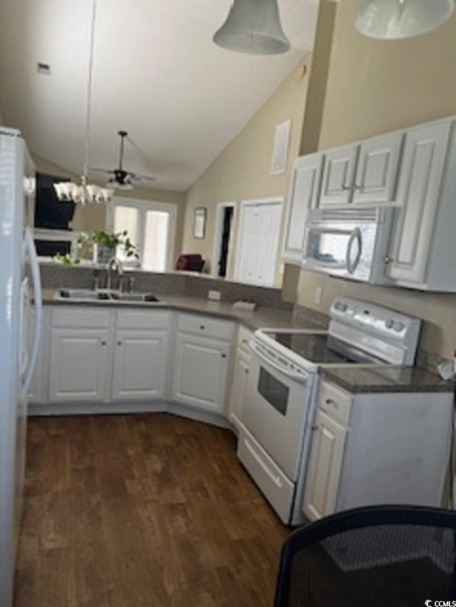 kitchen featuring dark wood-type flooring, kitchen peninsula, sink, white cabinetry, and white appliances