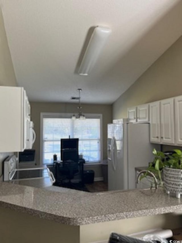 kitchen featuring decorative light fixtures, a notable chandelier, vaulted ceiling, white cabinets, and white appliances