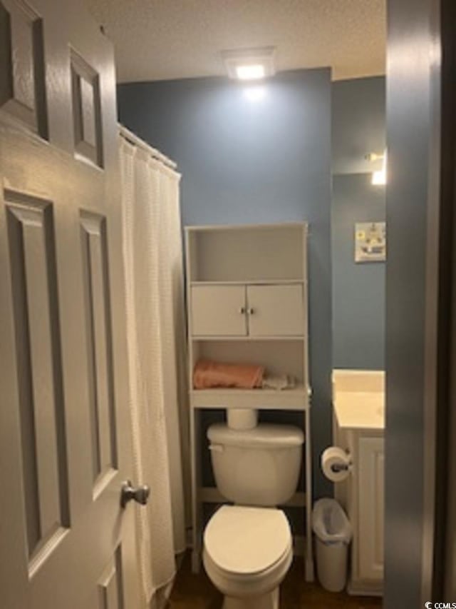 bathroom with vanity, toilet, and a shower with shower curtain