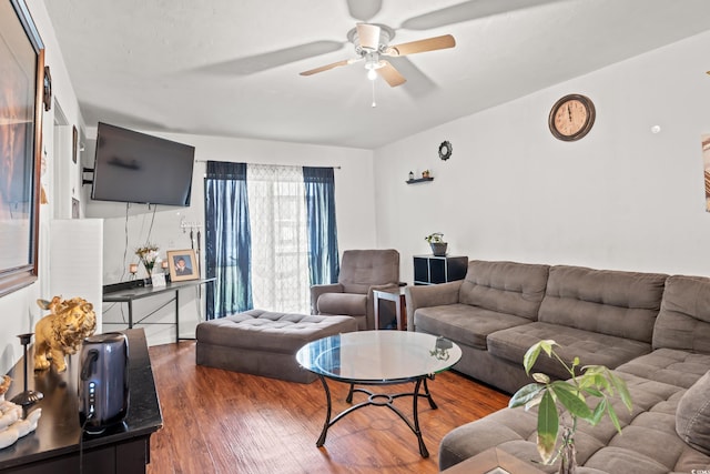 living room featuring ceiling fan and dark wood-type flooring