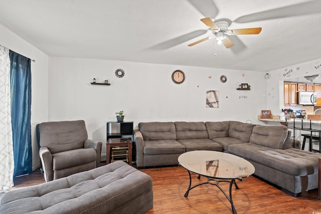 living room with ceiling fan and dark hardwood / wood-style flooring