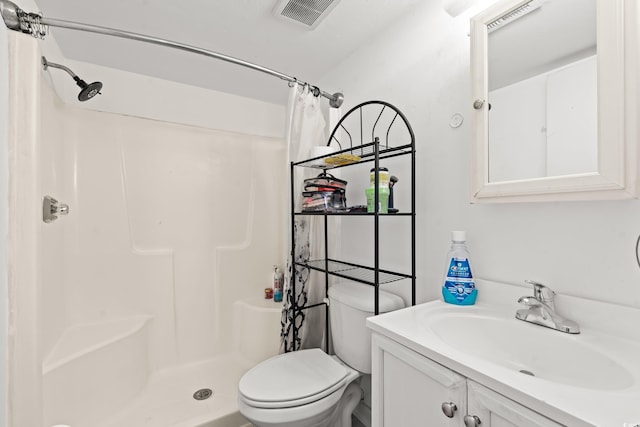 bathroom with vanity, toilet, and curtained shower