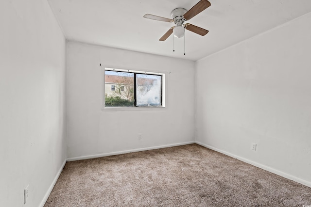 spare room with ceiling fan and carpet