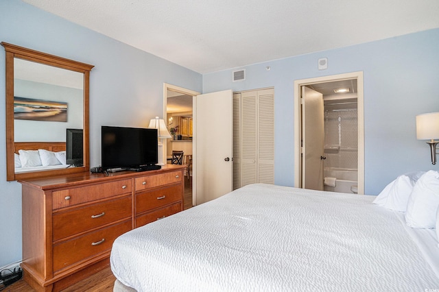 5308 N Ocean Blvd Unit 1014, Myrtle Beach, SC 29577 - bedroom with a closet, ensuite bathroom, and wood finished floors
