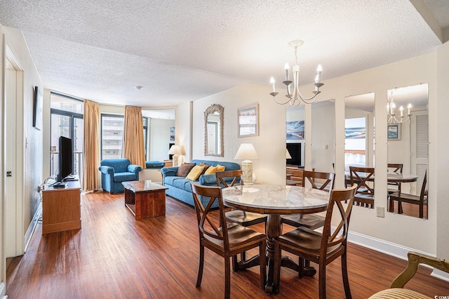 5308 N Ocean Blvd Unit 1014, Myrtle Beach, SC 29577 - dining area featuring a chandelier, a textured ceiling, dark wood-style floors, and baseboards