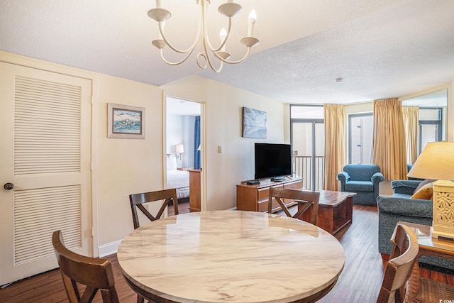 5308 N Ocean Blvd Unit 1014, Myrtle Beach, SC 29577 - dining area featuring dark wood-style flooring, a chandelier, a textured ceiling, and baseboards