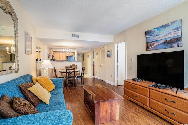 5308 N Ocean Blvd Unit 1014, Myrtle Beach, SC 29577 - living room featuring a chandelier, wood finished floors, and baseboards
