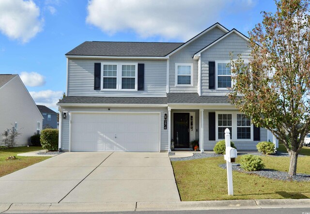 view of front facade featuring a front yard and a garage