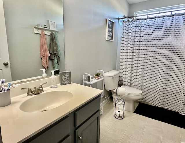 bathroom featuring toilet, vanity, tile patterned flooring, and a shower with shower curtain