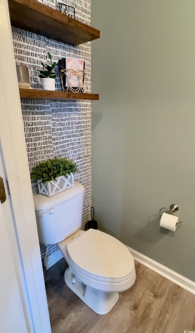 bathroom with hardwood / wood-style flooring and toilet