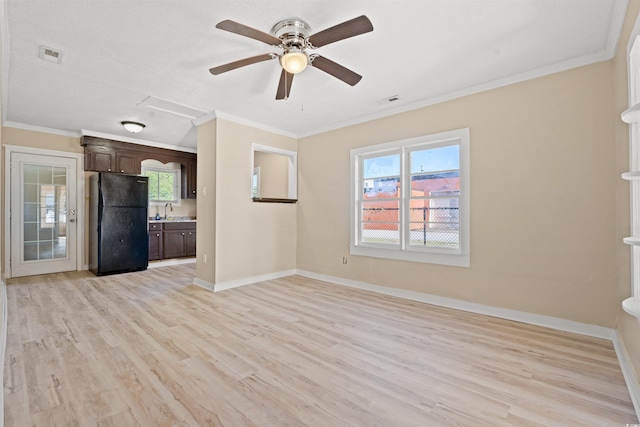 unfurnished living room featuring light hardwood / wood-style floors, ceiling fan, and crown molding