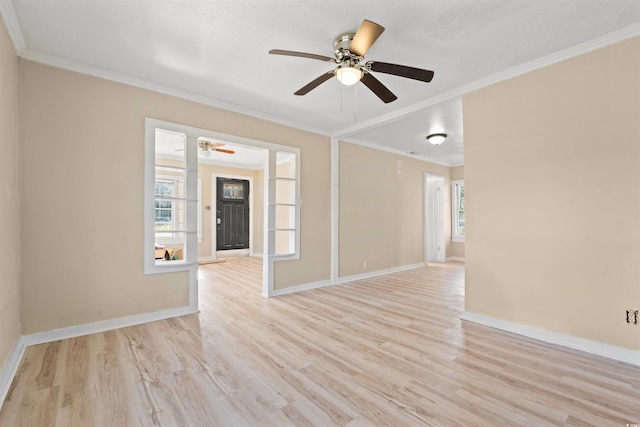 spare room featuring a textured ceiling, light hardwood / wood-style floors, ceiling fan, and crown molding