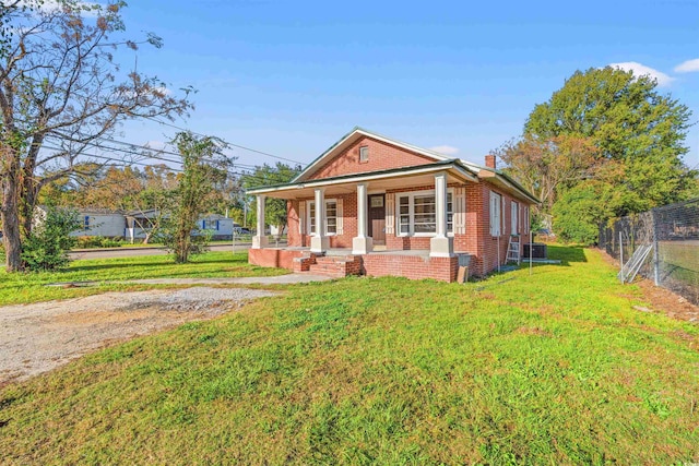 view of front of property featuring central AC, a front lawn, and a porch