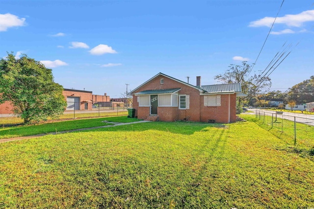 back of property with a lawn