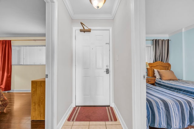 entryway with hardwood / wood-style flooring and ornamental molding