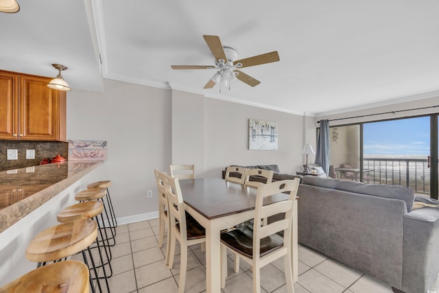 dining area featuring ornamental molding, ceiling fan, and light tile patterned flooring