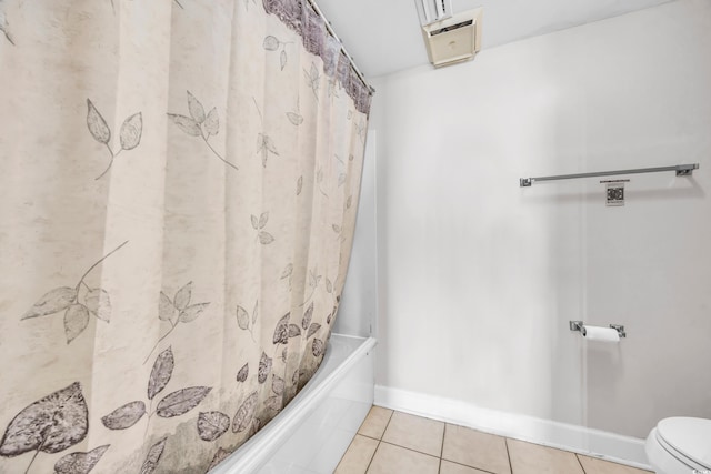 bathroom with toilet, shower / bath combo, and tile patterned floors