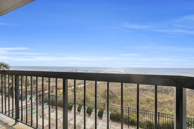 balcony featuring a beach view and a water view