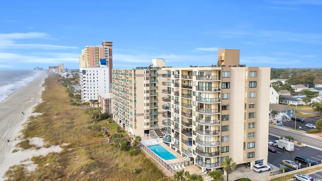 view of property with a view of the beach and a water view