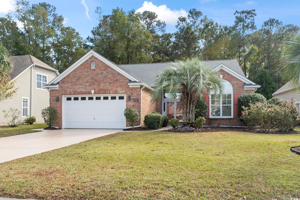 view of front of property featuring a garage and a front lawn