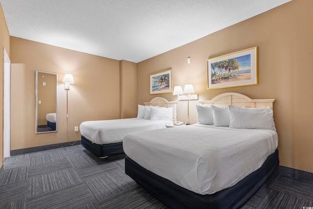 carpeted bedroom featuring a textured ceiling