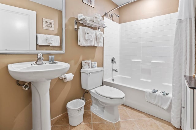 bathroom featuring tile patterned floors, toilet, and shower / bathtub combination with curtain